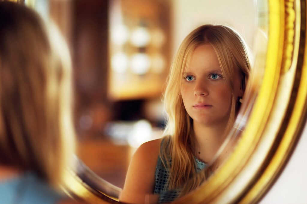 person looking at reflection representing losing yourself in a relationship