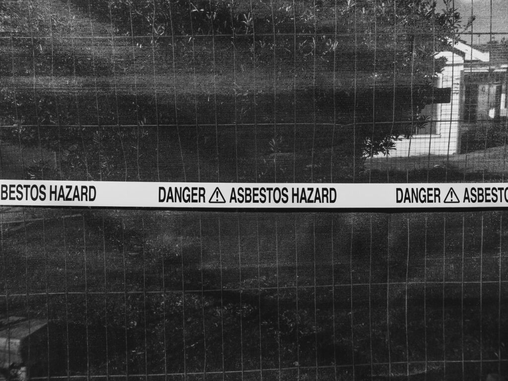 Warning tape marking an asbestos hazard area during building inspection or remediation