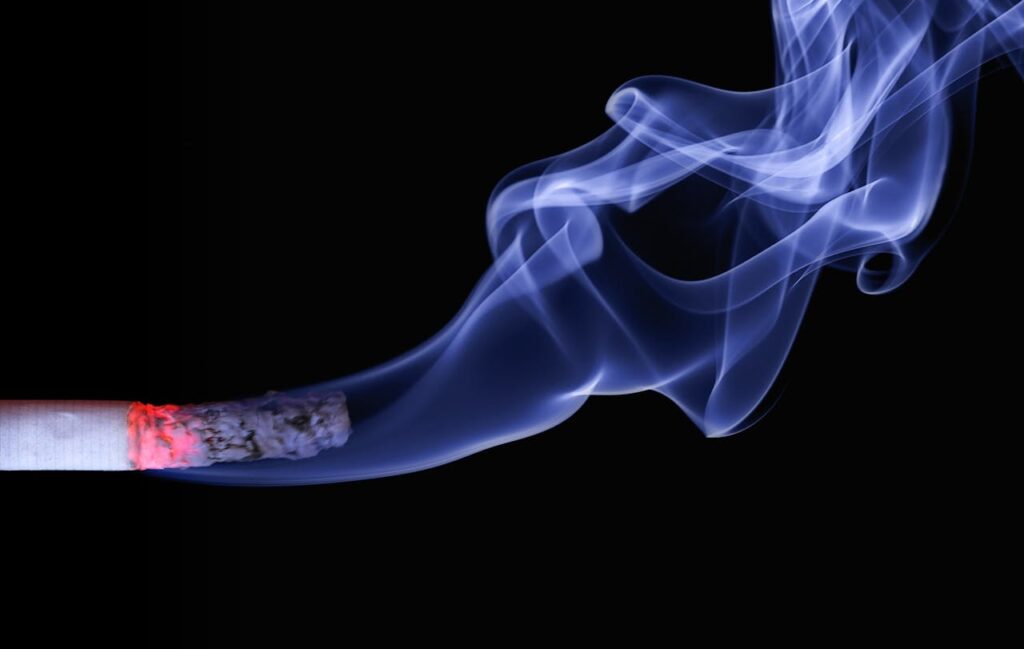cigarette smoke representing tobacco industry cover-up deadly silence for 50 years