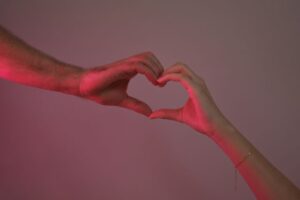 Love and trauma bonding relationship concept with hands forming a heart shape