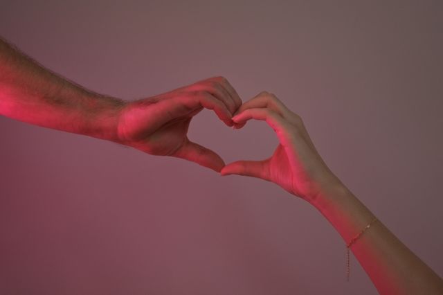 Love and trauma bonding relationship concept with hands forming a heart shape