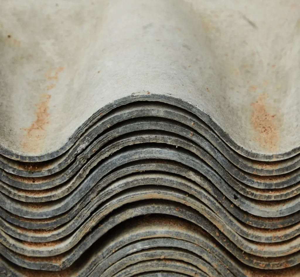 Stacked asbestos cement roofing sheets once widely used in construction and industrial buildings