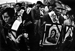 Families affected by Minamata disease carry portraits of loved ones during a demonstration calling for justice and recognition.